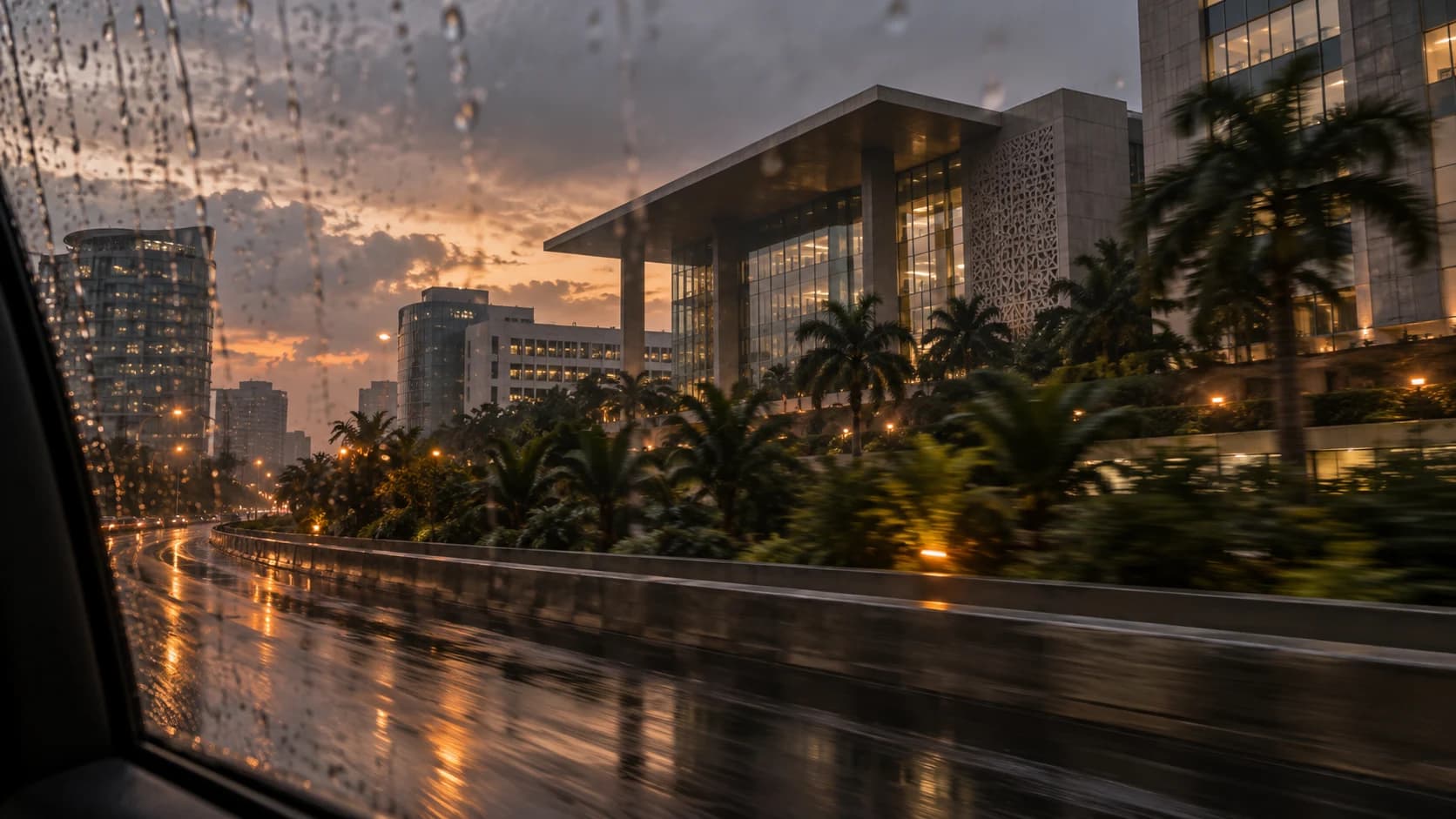 Premium Nigerian urban architecture seen through a rain-streaked moving window